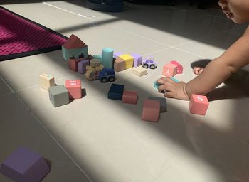 High angle view of child playing with toy on floor