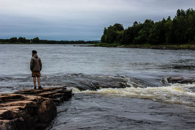 Tourists standing on rock