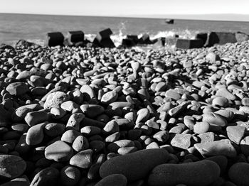 Rocks on beach against sky