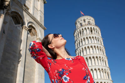 Low angle view of woman against building