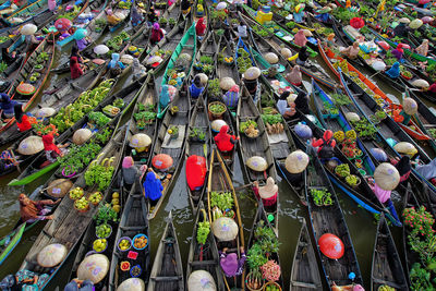 High angle view of people selling vegetables in boats at floating market