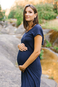 Portrait of young woman standing outdoors