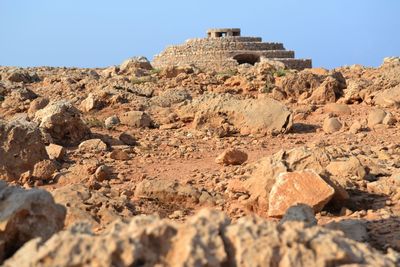 Rock formations on landscape against clear sky