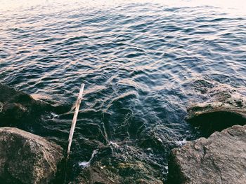 High angle view of rocks by sea