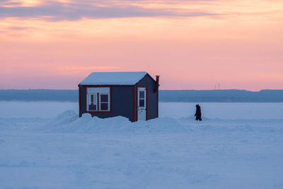 House on snow covered landscape