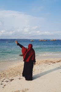 Rear view of muslim girl on beach