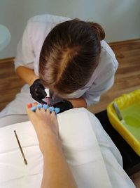 High angle view of woman getting pedicure at nail salon
