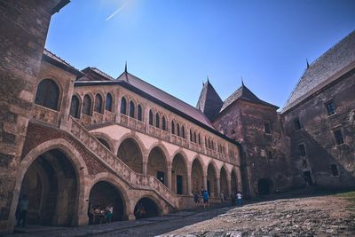 Low angle view of historical building against blue sky