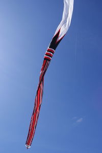 Low angle view of flags against blue sky