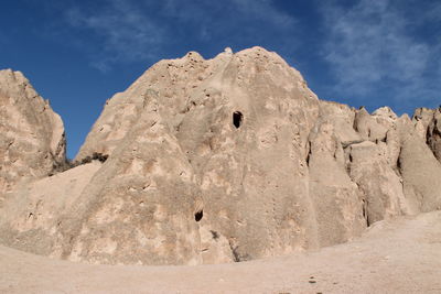 Low angle view of rock formation against blue sky