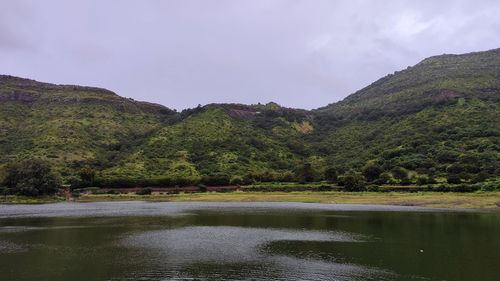 Scenic view of lake and mountains against sky