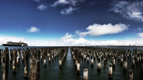 View of wooden posts in sea