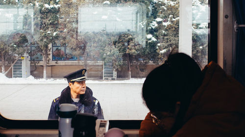 People looking through window