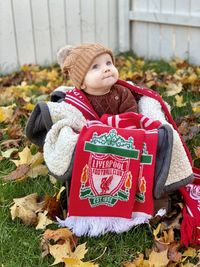 Full length of cute baby girl lying on field