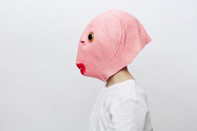 Rear view of woman wearing mask against white background