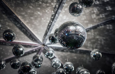 Low angle view of disco balls hanging from ceiling