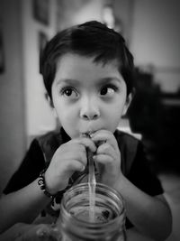 Boy sipping drink at home