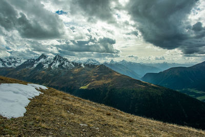 Scenic view of mountains against cloudy sky