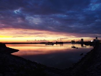 View of lake against cloudy sky during sunset