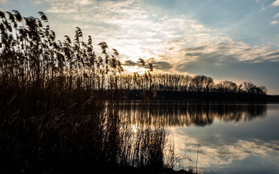 Scenic view of lake against sky during sunset