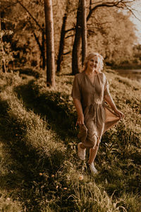 Portrait of young woman sitting on field