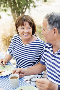 Mature couple having meal outdoor