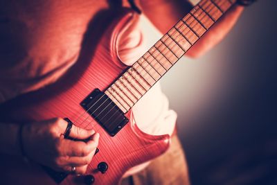 Close-up of man playing guitar