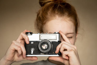 Cropped hand of man photographing with camera