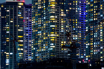 Illuminated modern buildings in city at night