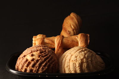 Close-up of bread against black background