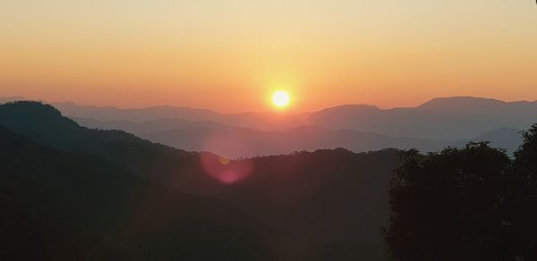 Scenic view of silhouette mountains against sky during sunset