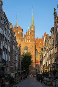 Street amidst buildings against sky in city