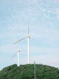 Low angle view of windmill - power in nature against the cloud sky.