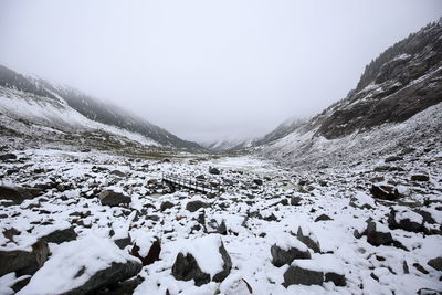 Scenic view of frozen lake against sky during winter