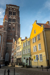 Low angle view of buildings in city against sky