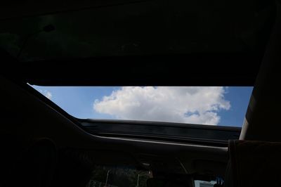 Low angle view of sky seen through car window