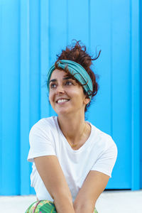 Portrait of beautiful tanned woman on holidays. isolated woman on blue background. happiness concept