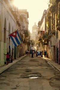 People on street in city against sky