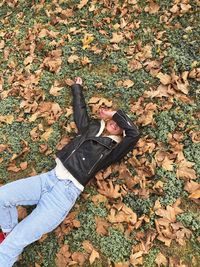 High angle view of woman lying down on field