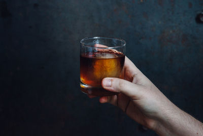 Cropped hand of woman holding drink