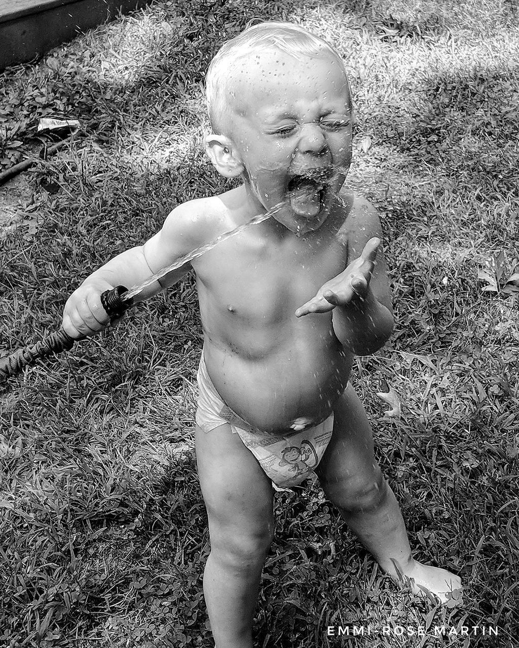 HIGH ANGLE VIEW OF CUTE BABY BOY ON FIELD