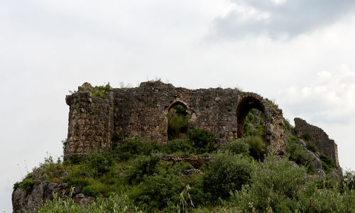 Low angle view of old ruin against sky