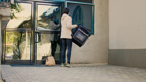 Rear view of woman walking in city