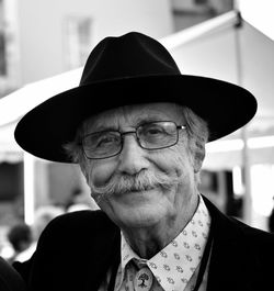 Close-up portrait of smiling man wearing hat