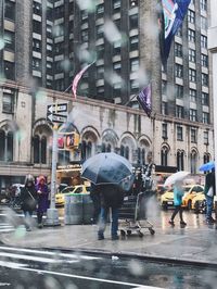 People walking on street in rain