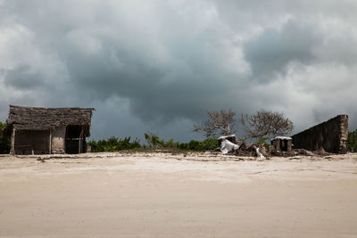 Abandoned building on land against sky