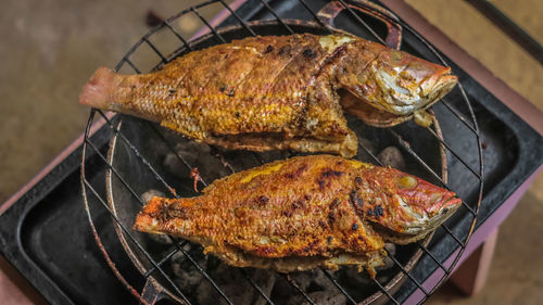 Close-up of fish on barbecue grill