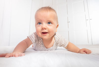 Cute baby boy sleeping on bed at home