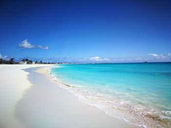 Scenic view of beach against blue sky