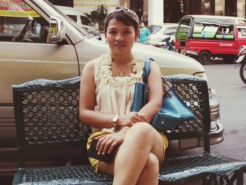 Portrait of woman sitting on bench